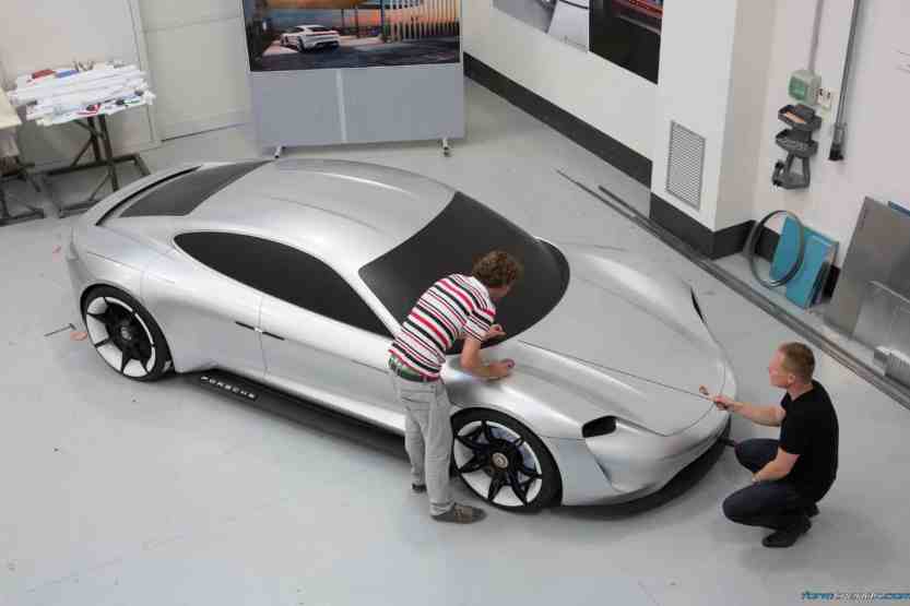 Exterior designer Emiel Burki and exterior design chief Mitja Borkert with a full-size model of the Porsche Mission E
