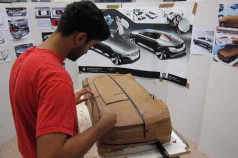 A student works on developing the concept in a quarter scale model